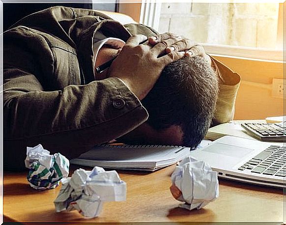 Man who puts his head on the table out of frustration, because dealing with negative people can be very frustrating