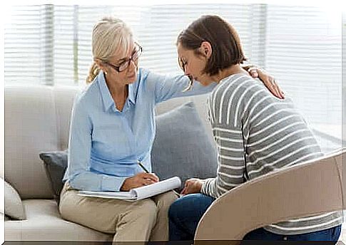 A woman is comforted by a therapist