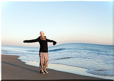 Woman with cancer enjoying the fresh air on the beach