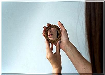 Woman looks at her own reflection