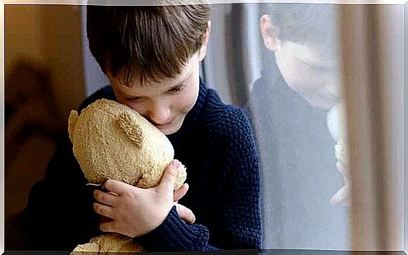 Little boy hugs his teddy bear