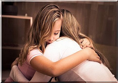 Mother and daughter hug each other