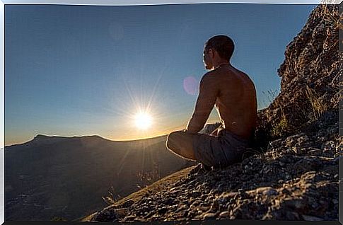 Man meditating on a rock