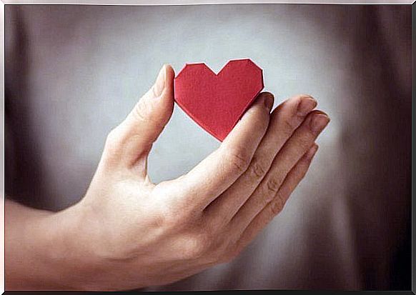 Woman holds heart in her hands: taking good care of yourself is important