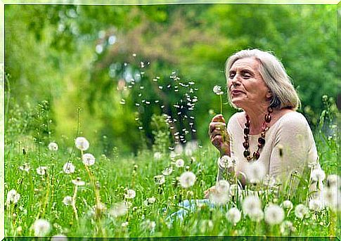 Elderly woman in flower field